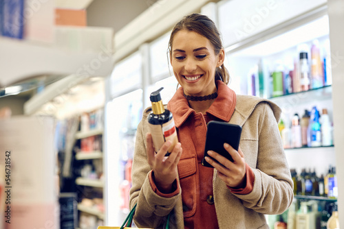 Fotografie Happy woman enjoying in shopping skin care products in drugstore.