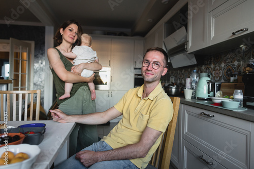 Spouses and baby in the kitchen photo