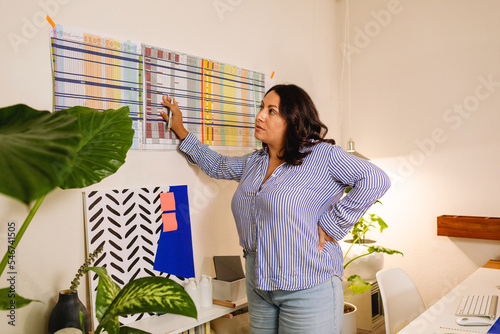 Hispanic woman working in modern office