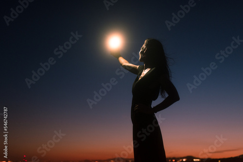 Happy woman taking selfies during sunset