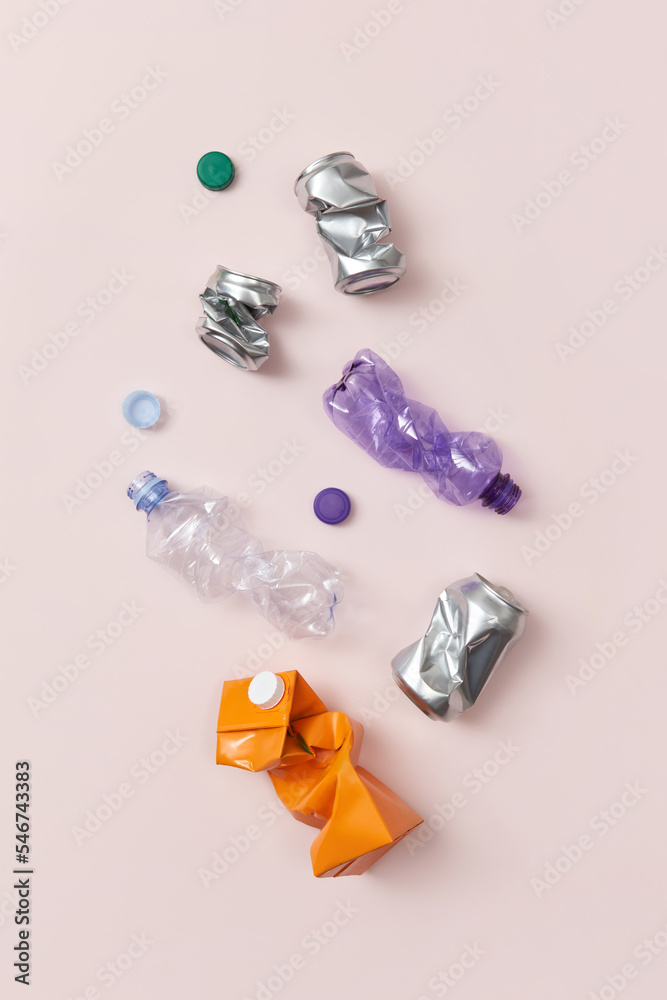 Metal and plastic waste on beige background. Metal and plastic waste on beige background.