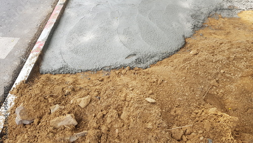 Pour the cement onto the compacted path to be a walkway.