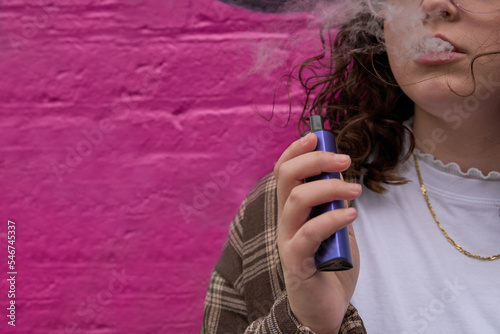 Young smoker with e-cigarette photo