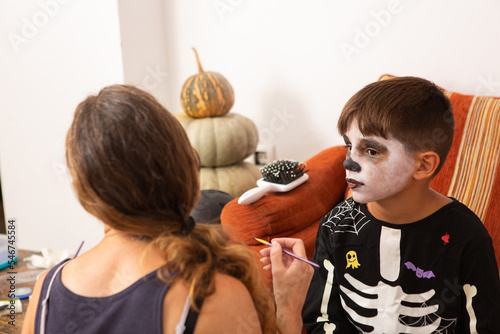 Little boy has halloween face paint applied