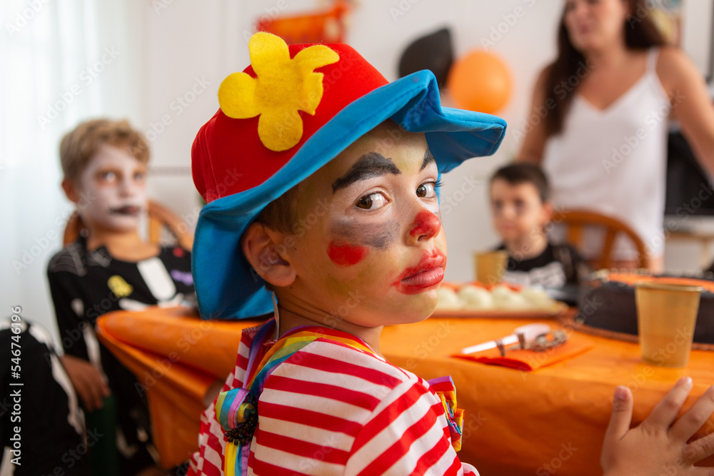 Children in halloween outfirs at party table Children in halloween outfirs at party table