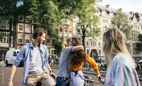 Group of happy friends greeting each other