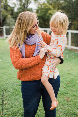 God mother interacting with goddaughter  photo