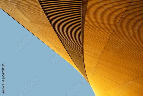 Elegant and abstract modern building exterior against blue sky photo