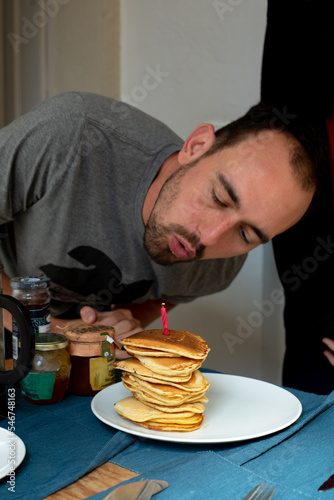 Happy birthday candid home celebration with candle photo