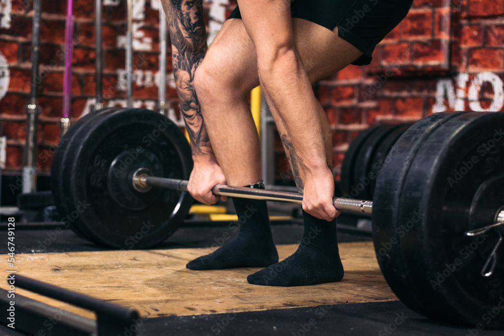 Unrecognizable man training deadlift in the gym Unrecognizable man training deadlift in the gym
