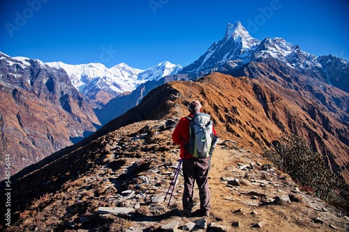 Obraz na plátně Senior man standing on the ridge in Himalayas mountains