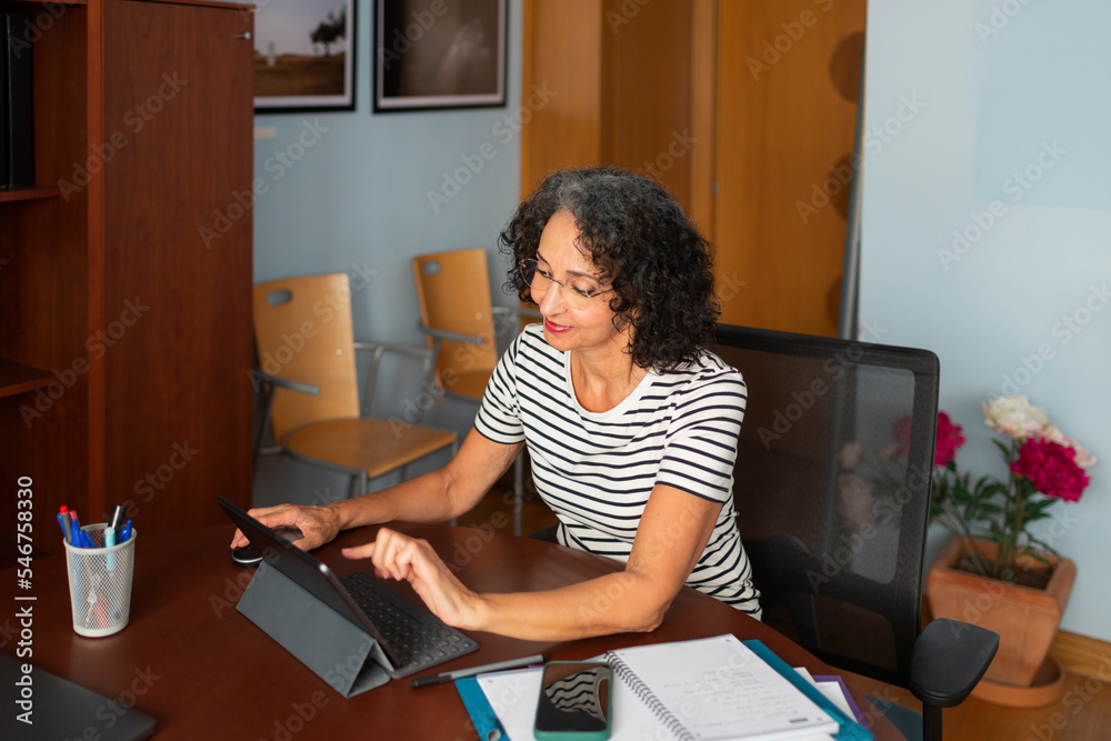 © Lightsy/Stocksy - Lawyer working on a tablet at a meeting table