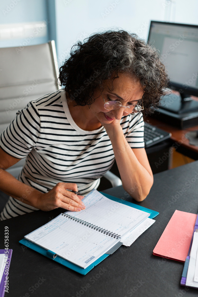 Woman taking notes at the office Woman taking notes at the office