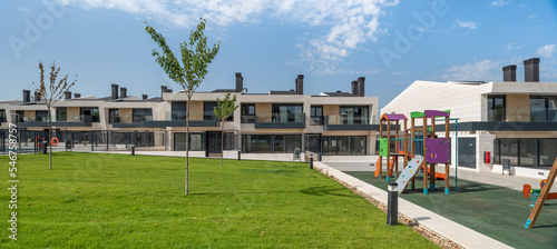 Modern home residential building complex with children park playground photo