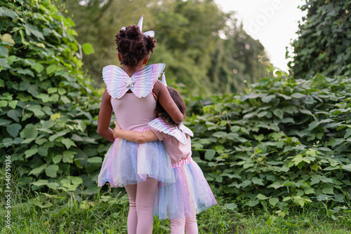 two girls in festive costumes at nature