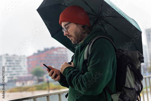 man under green umbrella photo