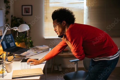 Mixed race freelancer multitasking in office