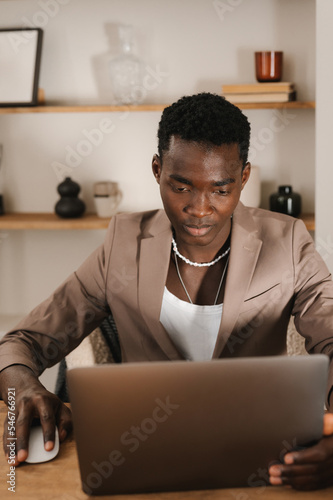 Serious  freelancer using netbook at desk at home
