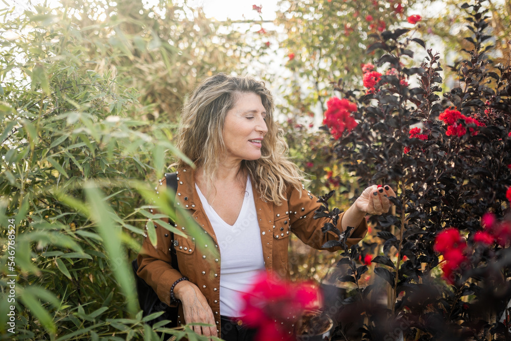 mature woman in a greenhouse mature woman in a greenhouse