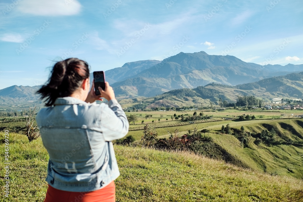 Woman taking a picture of the landscape Woman taking a picture of the landscape