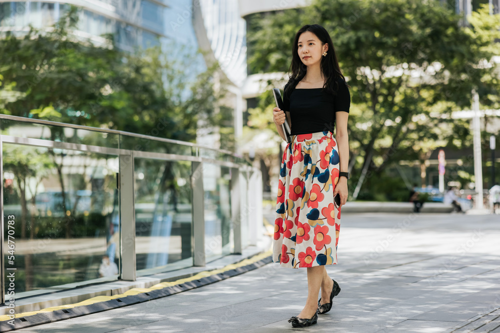 Asian office lady walking in the CBD of the City Asian office lady walking in the CBD of the City