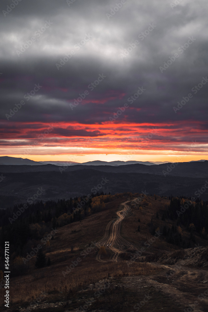 Mountain range. Autumn landscape in the evening with long road. Mountain range. Autumn landscape in the evening with long road.