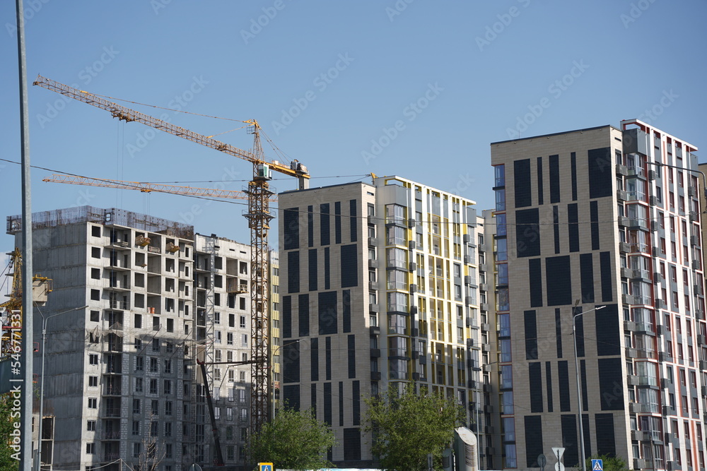 Almaty, Kazakhstan - 04.26.2022 : Construction of a high-rise residential complex near a road junction.