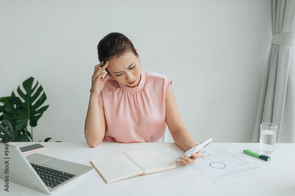 Closeup businesswoman looking graph chart paper and calculate Closeup businesswoman looking graph chart paper and calculate