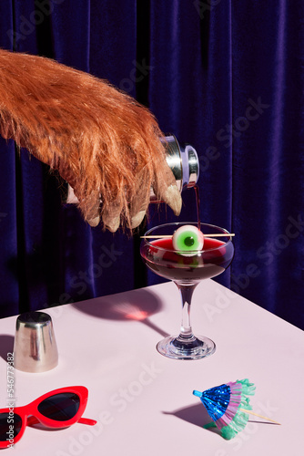 Furry claw pouring halloween cocktail