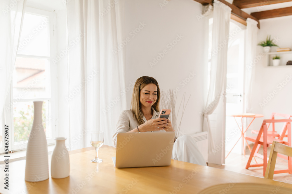 Happy businesswoman using smartphone at home Happy businesswoman using smartphone at home