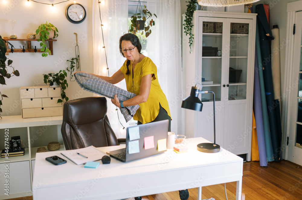 middle-aged woman in home office holding coffee cup middle-aged woman in home office holding coffee cup