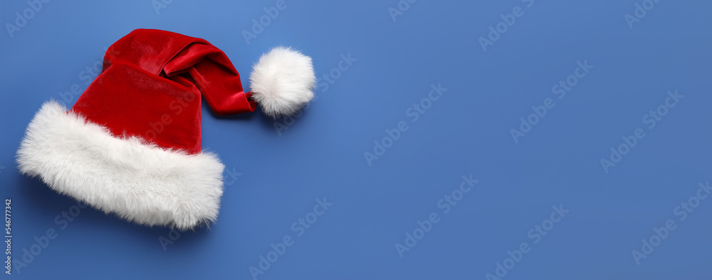 Santa hat on blue background with space for text