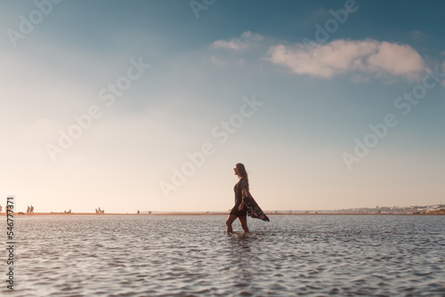 Portrait of woman walking in shore water photo