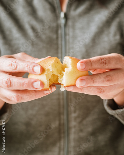 Woman's hands splitting an almojabana photo