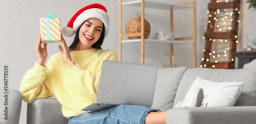Young woman with laptop cel...
