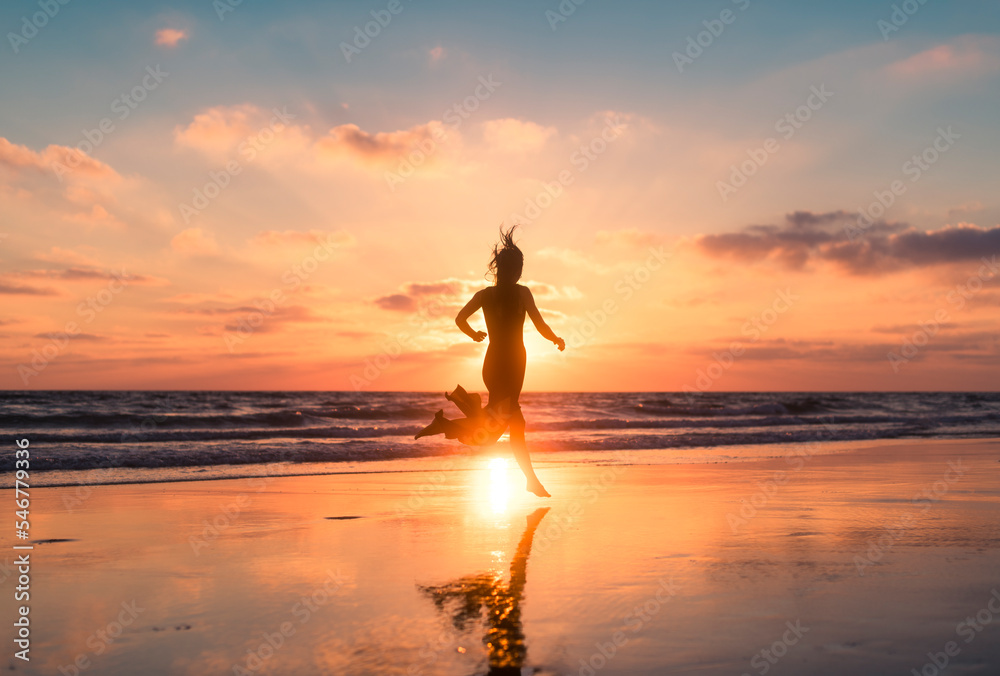 Woman silhouette running full of vitality at beach Woman silhouette running full of vitality at beach
