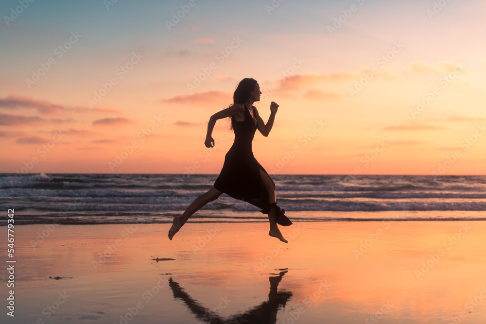 Happy woman running across dreamlike beach shore Happy woman running across dreamlike beach shore