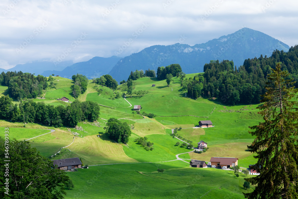 Panoramic view of countryside, green alpine meadows and mountains