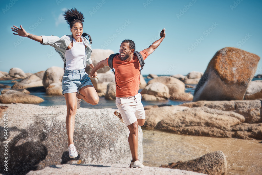 Beach, freedom and happy couple jumping on rocks together while on seaside summer vacation. Happiness, travel and young man and woman in nature by the ocean on holiday, adventure or journey in Mexico Beach, freedom and happy couple jumping on rocks together while on seaside summer vacation. Happiness, travel and young man and woman in nature by the ocean on holiday, adventure or journey in Mexico