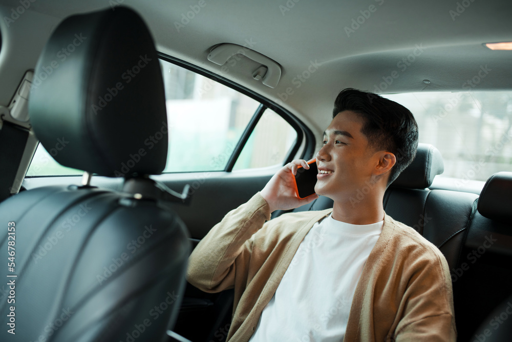 Handsome businessman using mobile phone in car. Happy face. Handsome businessman using mobile phone in car. Happy face.