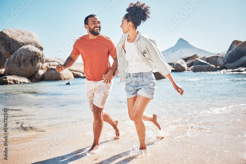 Black couple, beach and running while happy on vacation in summer with energy, love and happiness while outdoor. Man and woman together by the sea for honeymoon, holiday and quality time in nature #546782543