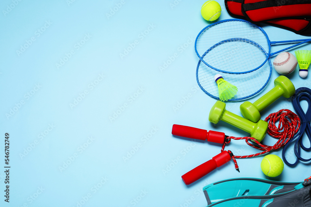 Set of different sports equipment on light blue background, flat lay. Space for text - obrazy, fototapety, plakaty 