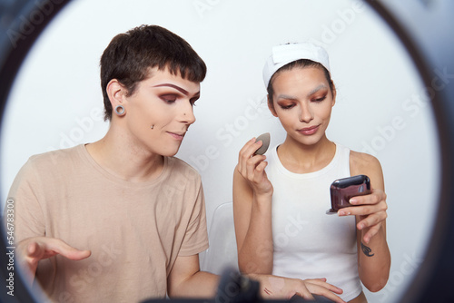 Beauty bloggers recording their makeup routine photo