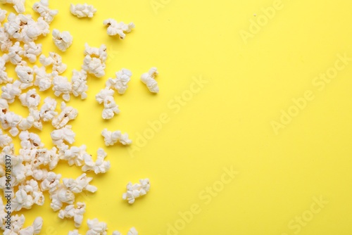Tasty pop corn on yellow background  flat lay. Space for text
