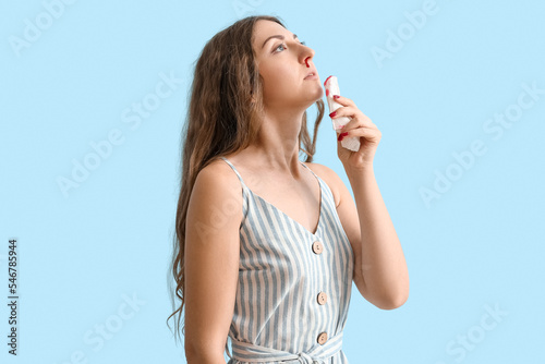 Young woman with nosebleed ...
