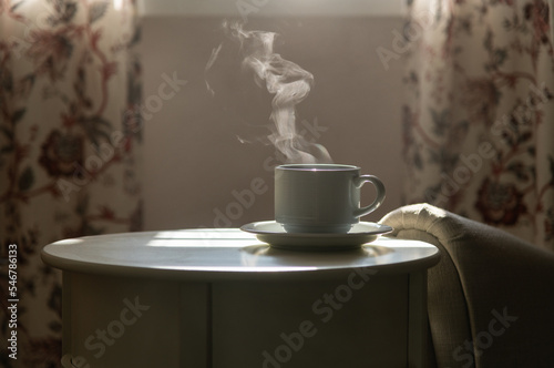 Detail shot - coffee mug on table with steam rising above