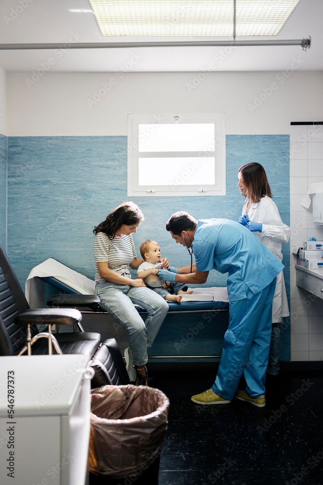Doctor examining girl with stethoscope in hospital Doctor examining girl with stethoscope in hospital