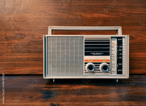old grey radio on wooden table