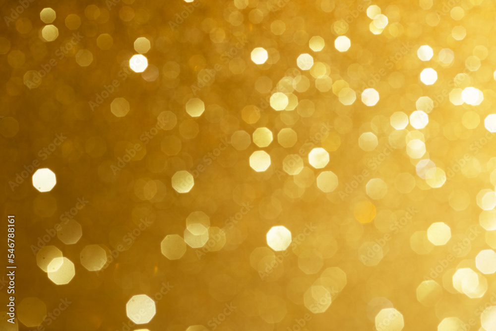Golden glittering background for design and free space.