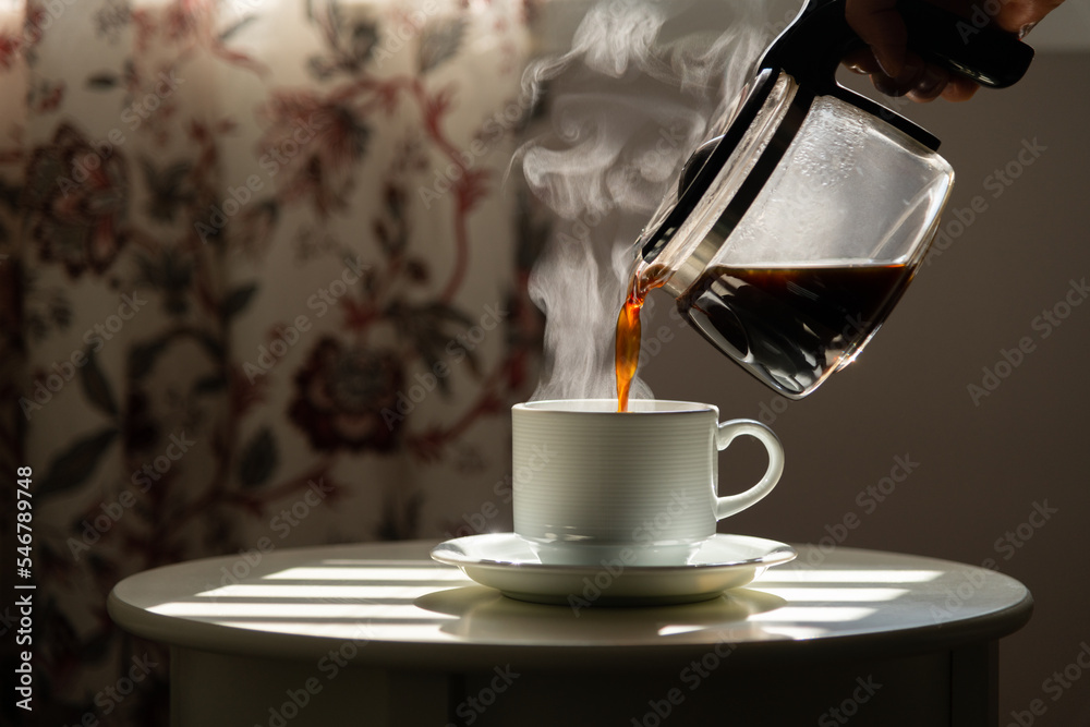Detail shot - hand holding coffee mug at home, grabbing to drink. Detail shot - hand holding coffee mug at home, grabbing to drink.